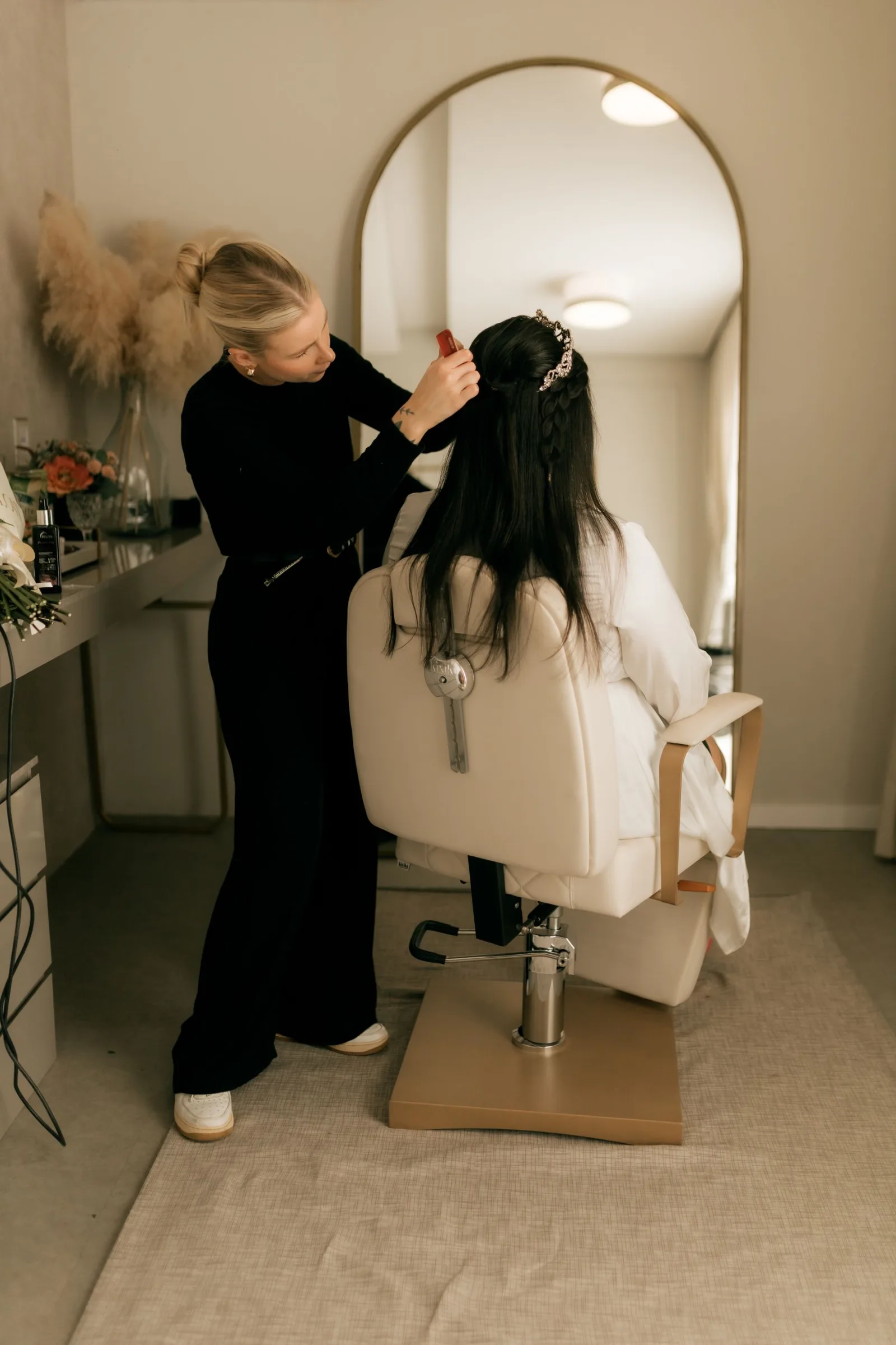 A stylist preparing a bride in the salon