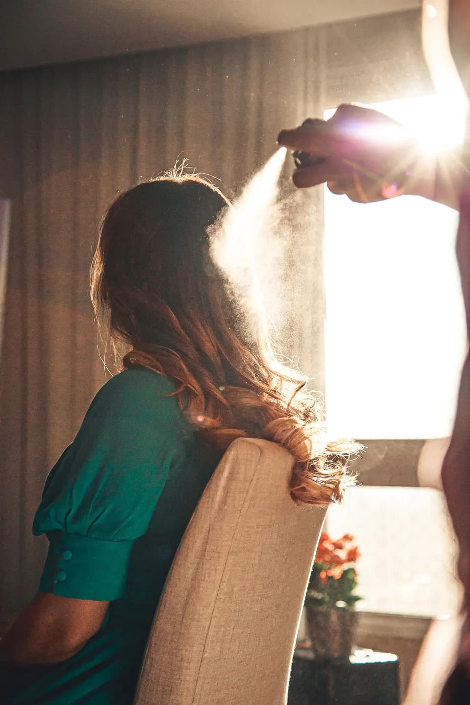 A stylist finishing a client, hands full