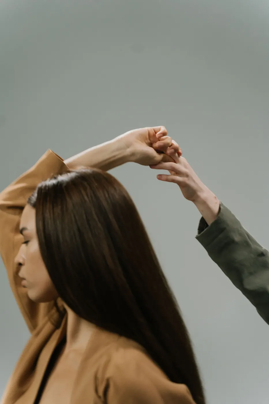 A stylist finishing a client's hair