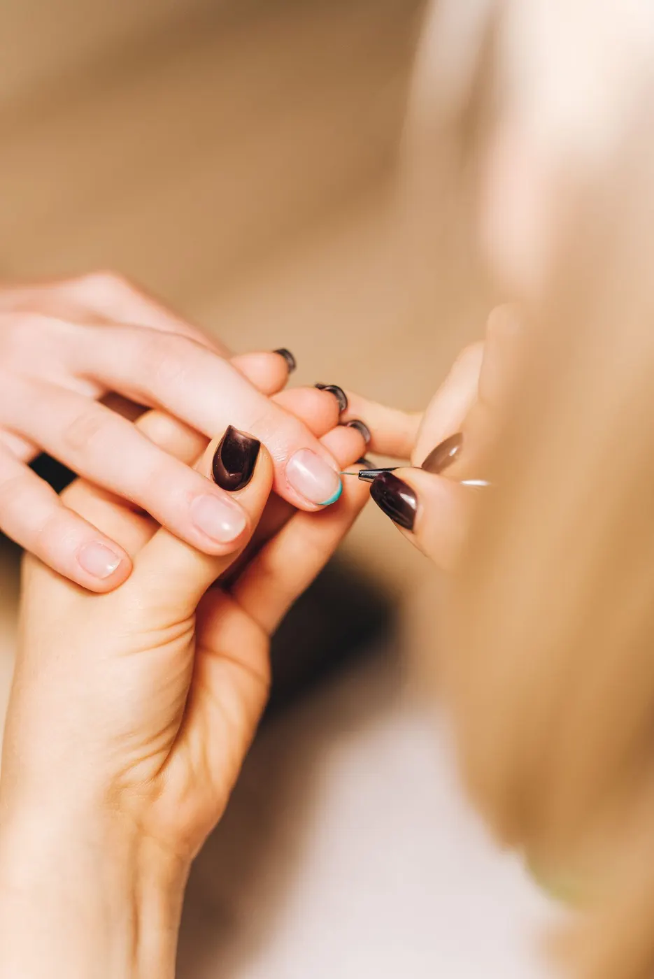 A nail artist finishing a set
