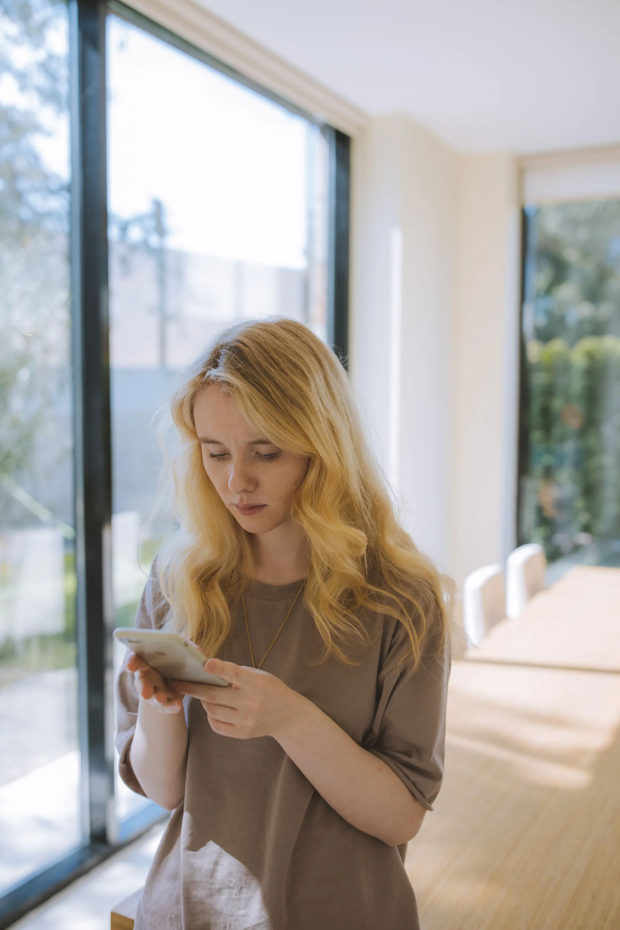 A client reading her messages by a bright window