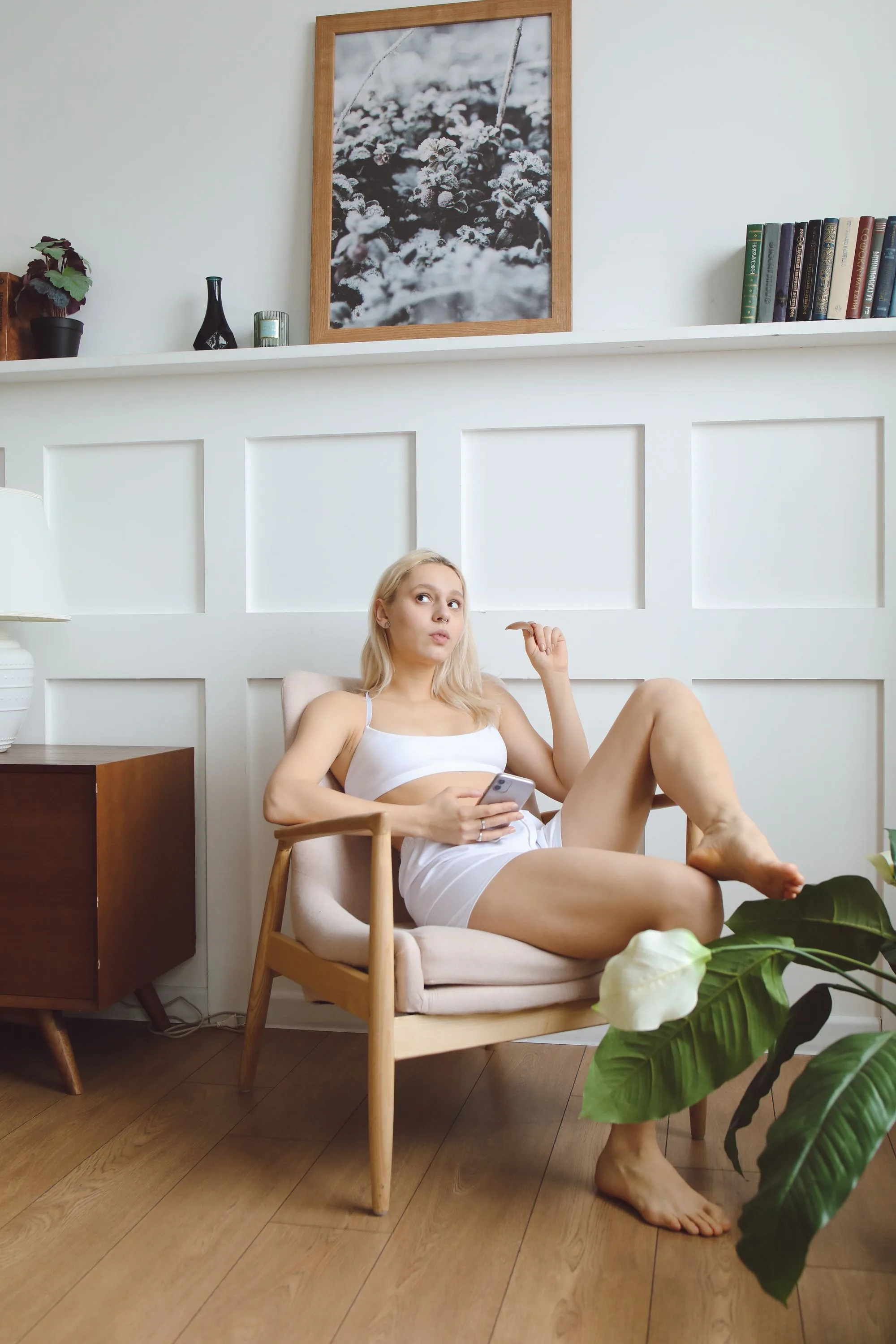 A salon owner relaxing at home in a panelled living room