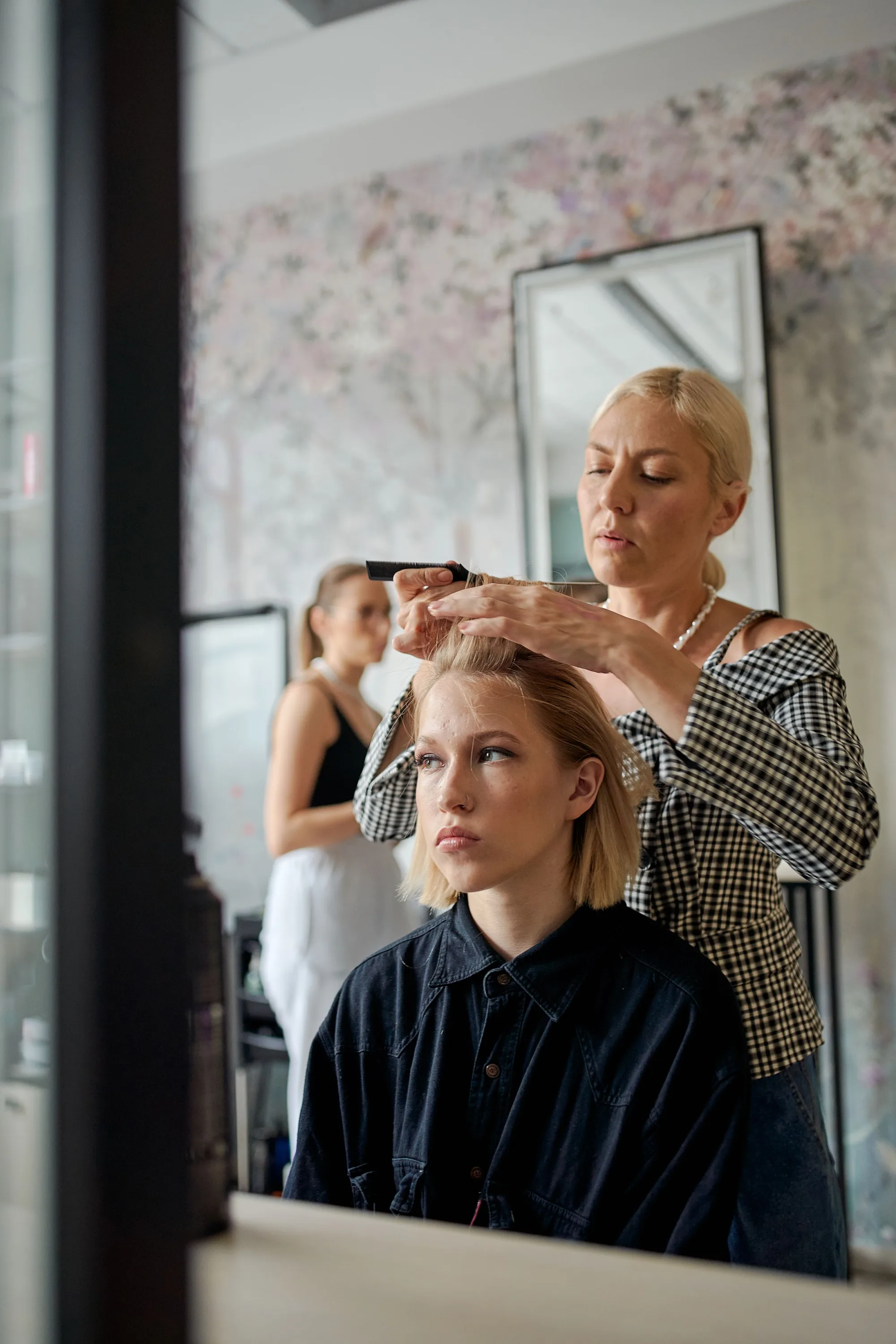 A stylist straightening a client's hair