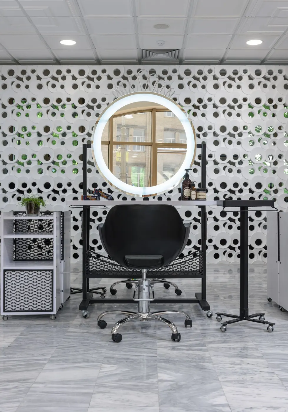 A styling chair and mirror in a bright salon
