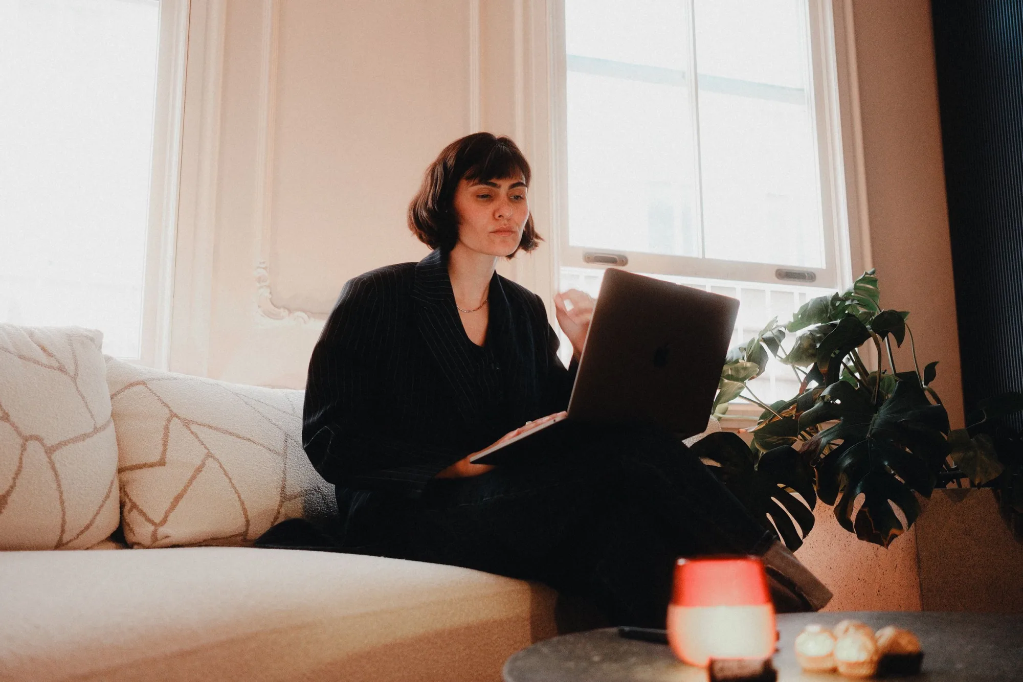 A woman working on a laptop at home